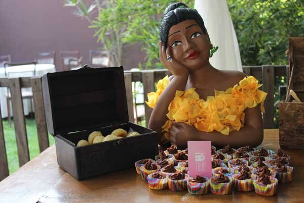 namoradeira perto do pão de queijo e do cupcake em coffee break de evento